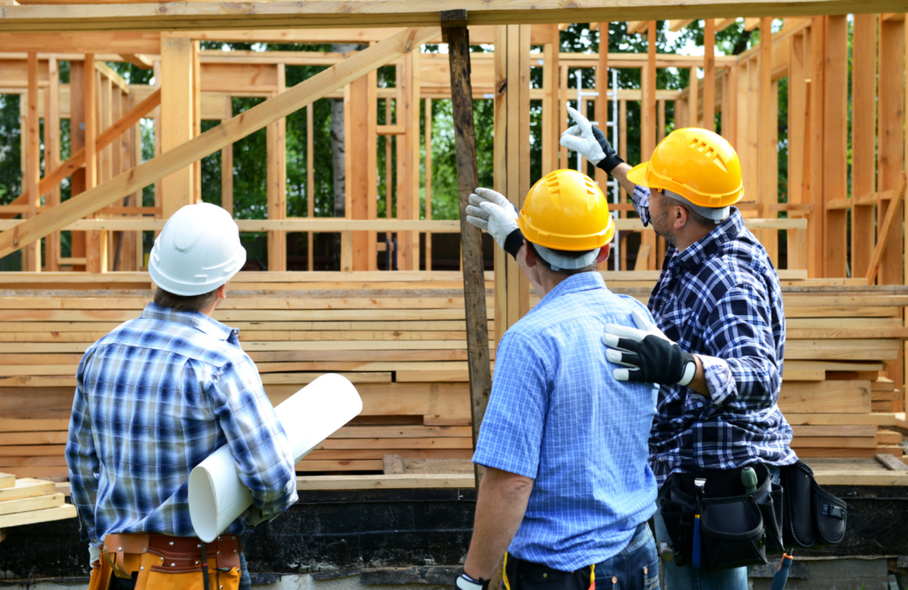 3 construction workers looking at job